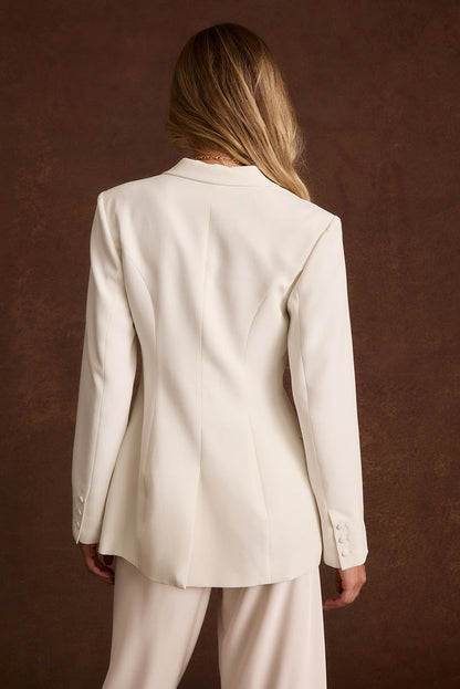 Back view of the Chloe white tapered blazer with seamed waist and buttoned cuffs.