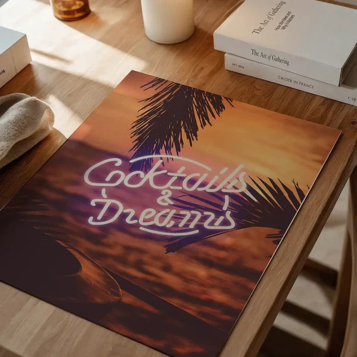 Cocktails and Dreams neon sign art print featuring palm silhouettes against a sunset beach background on archival paper.