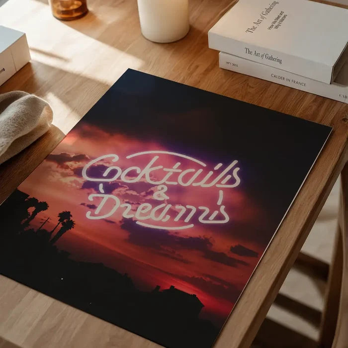 Cocktails and Dreams neon sign art print featuring a vibrant sunset, palm trees, and silhouettes on glossy paper.