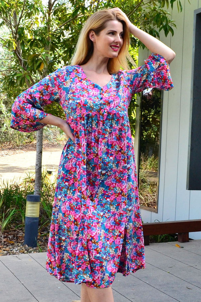 Colorful floral garden tunic dress by Hourglass featuring vibrant flower patterns and lightweight fabric, perfect for casual wear.