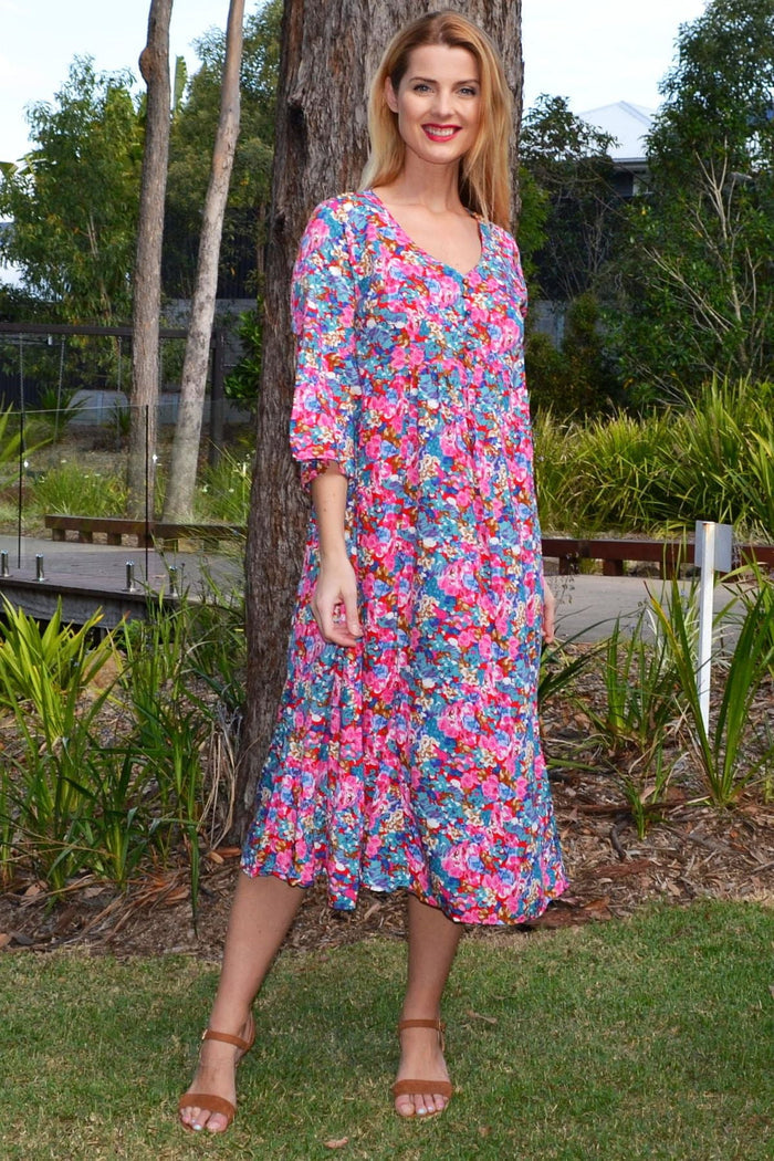 Colourful floral garden tunic dress by Hourglass with vibrant flower print, flowing fabric, and relaxed fit.