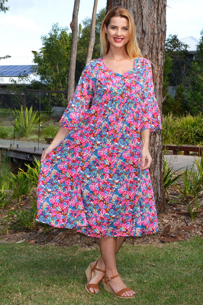 Colorful floral garden tunic dress by Hourglass featuring vibrant flower patterns and a relaxed fit, perfect for casual wear.