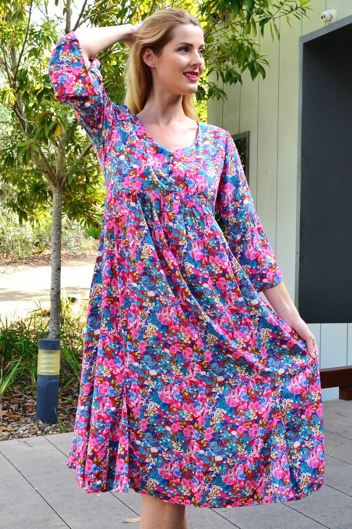 Colorful floral garden tunic dress by Hourglass with vibrant flower patterns and relaxed fit, perfect for casual summer wear.
