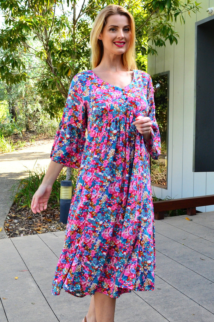 Colorful floral garden tunic dress by Hourglass, featuring vibrant flower patterns and lightweight fabric, perfect for spring and summer wear.