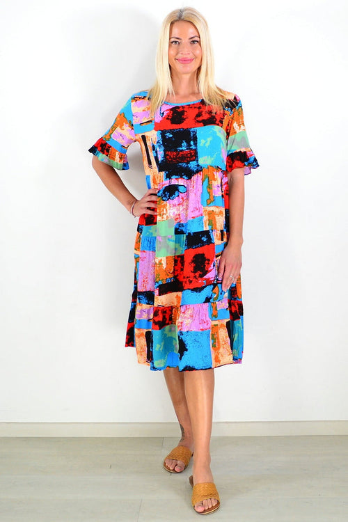 Colorful print patches on Hourglass tunic dress, showcasing vibrant patterns and a relaxed fit, perfect for casual wear.