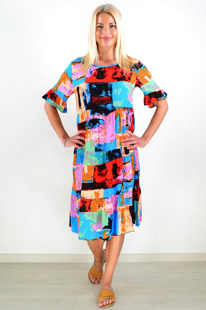 Colorful print patches tunic dress by Hourglass featuring vibrant patchwork design and comfortable fit, shown on a model.