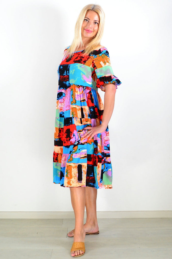 Colorful print patches tunic dress by Hourglass with vibrant patchwork design, flowing fabric, and casual style.