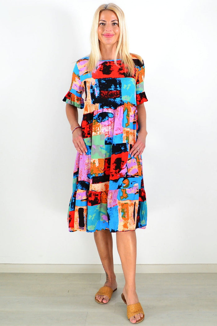 Colorful print patches on Hourglass tunic dress with long sleeves, casual style, and vibrant, eye-catching design.