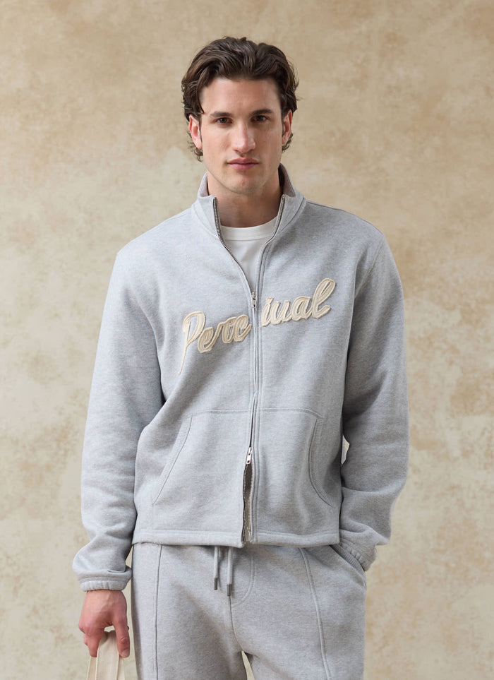 Percival Curtis boxy zip funnel neck sweatshirt in athletic grey organic cotton, featuring a cream script chest logo.