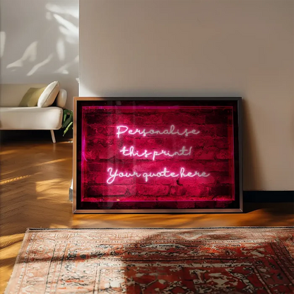 Custom neon-style print in a sleek frame featuring glowing white handwritten text against a dark red brick background.