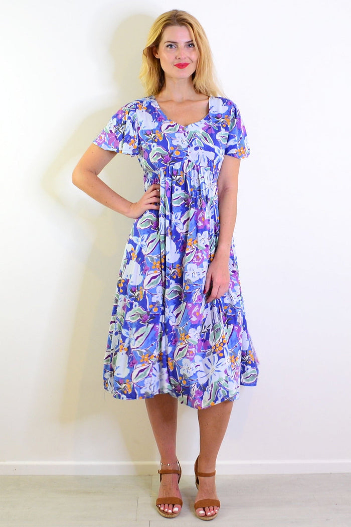 Hourglass Summer Garden Tunic Dress with floral print, lightweight fabric, and relaxed fit, perfect for warm weather.