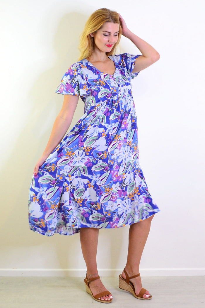Hourglass summer garden tunic dress with floral pattern, lightweight fabric, and relaxed fit displayed on a mannequin.
