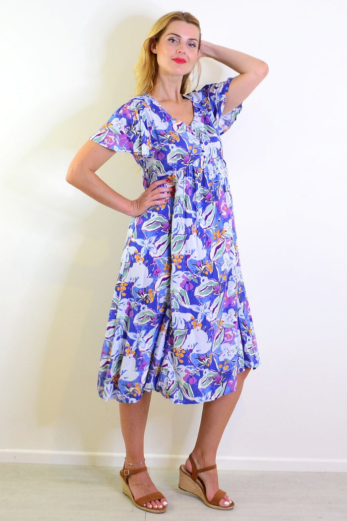 Hourglass summer garden tunic dress with floral print, lightweight fabric, and relaxed fit for casual warm-weather wear.