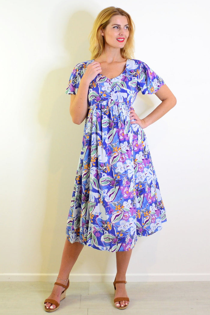 Hourglass summer garden tunic dress featuring floral patterns, lightweight fabric, and a relaxed fit perfect for warm weather.
