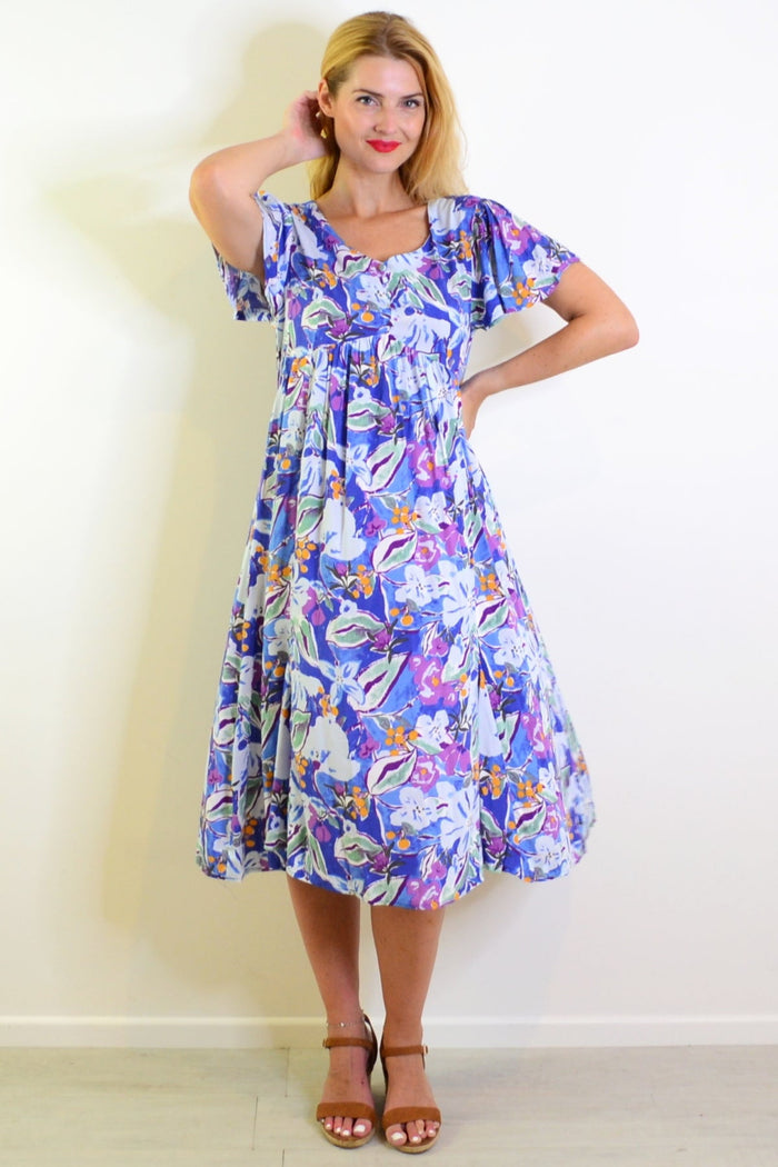 Hourglass summer garden tunic dress featuring floral patterns and lightweight fabric, perfect for casual warm-weather wear.
