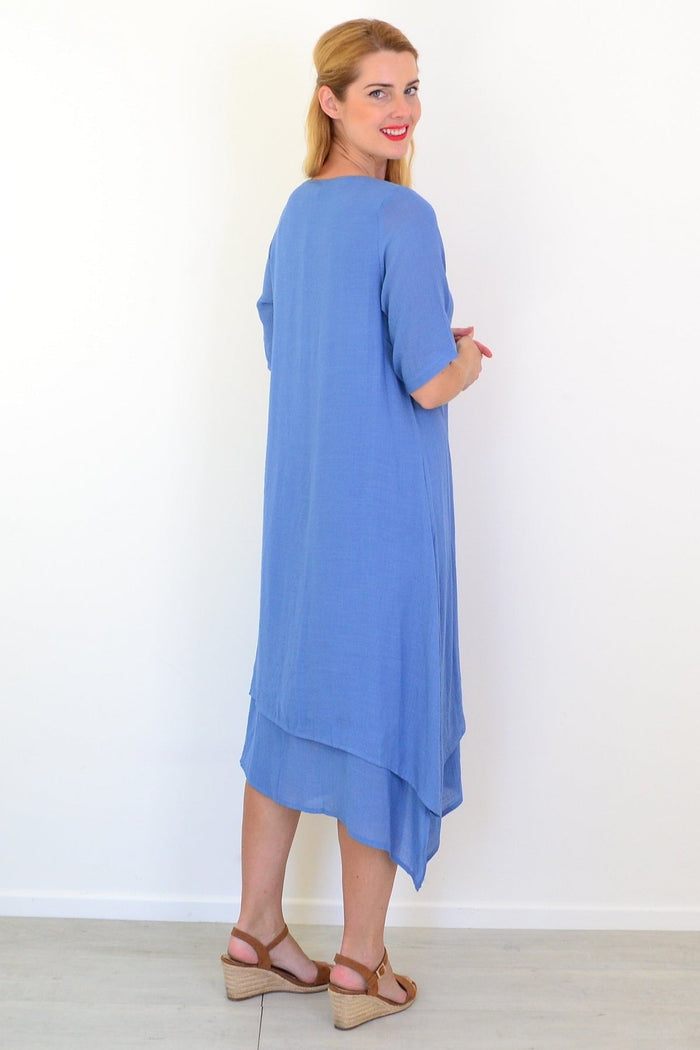 Denim blue summer tunic dress by La Mode displayed on a hanger with a flowy, casual style and sleeveless design.