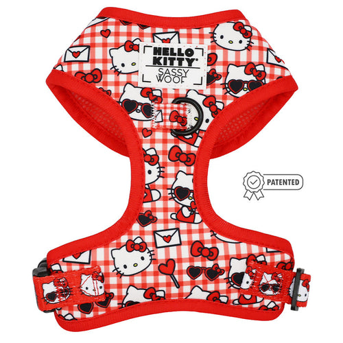 The Sassy Woof Dog Adjustable Harness - Hello Kitty® Red Classic features red and white plaid neoprene with Hello Kitty heads, bows, sunglasses, and tiny envelopes plus a Patented badge and signature label for a playful pup style.