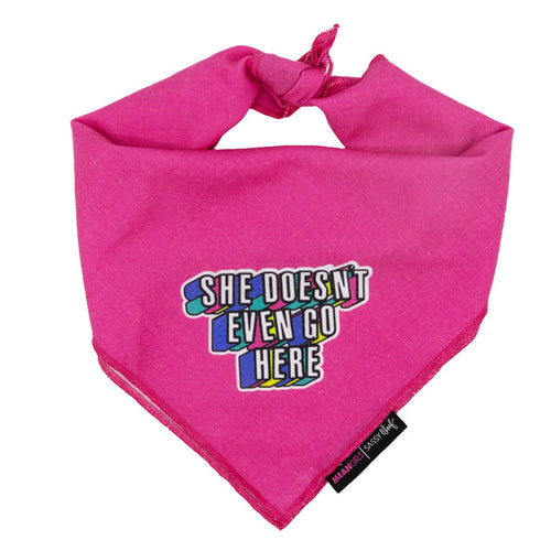 The Sassy Woof Dog Bandana - Mean Girls™ She Doesn't Even Go Here features a pink design with a top knot, a vibrant patch with the quote, and a black tag—adding playful style to your pup's wardrobe.