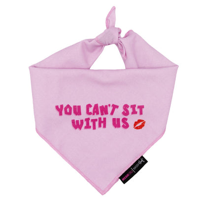 The Sassy Woof Dog Bandana - Mean Girls™ You Can't Sit With Us features bold pink text, a red lipstick kiss, and a black tag—ideal for dog fashion and pairs perfectly with an adjustable harness.