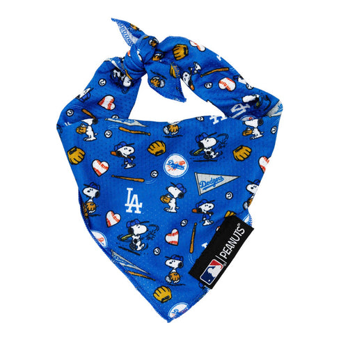 The Sassy Woof Dog Bandana - MLB™ x Peanuts™ Los Angeles Dodgers™ features Peanuts characters, Dodgers logos, and playful baseball icons. Includes a PEANUTS tag and official MLB branding.