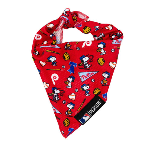 The Sassy Woof Dog Bandana – MLB™ x Peanuts™ Philadelphia Phillies™ features Snoopy in baseball poses with Phillies logos, gloves, bats, and caps—an ideal accessory for your dog with official Peanuts and MLB tags.