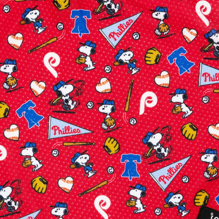 The Sassy Woof Dog Bandana - MLB™ x Peanuts™ Philadelphia Phillies™ features red fabric with Snoopy in a Phillies uniform, gloves, bats, balls, hearts & logos—great for making fun bandanas or MLB dog accessories.