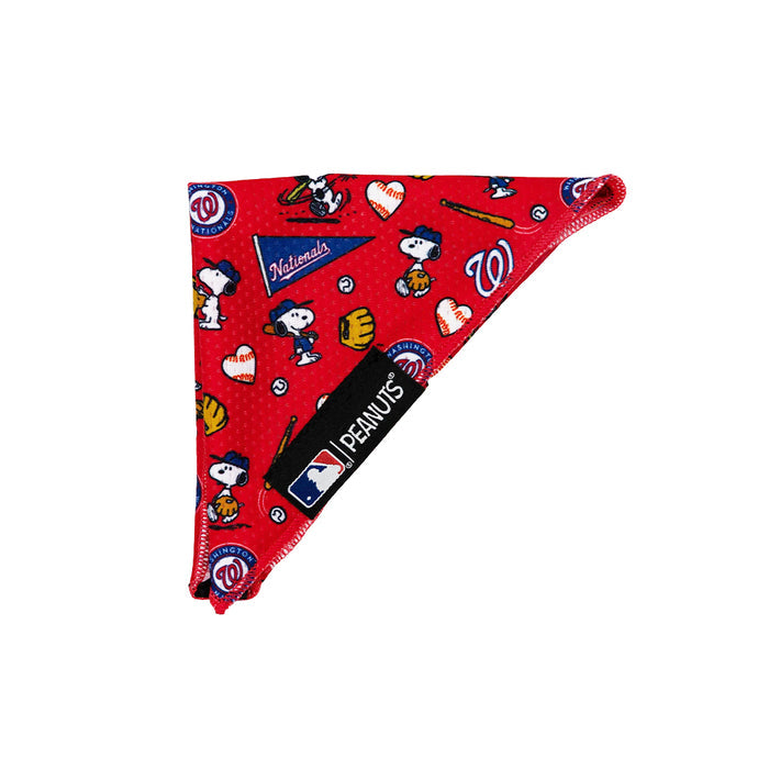 The Sassy Woof Dog Bandana - MLB™ x Peanuts™ Washington Nationals™ is a red triangular bandana with Snoopy baseball motifs, hearts, bats, team logos, and a black MLB Peanuts tag.