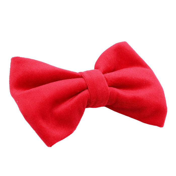 The Sassy Woof "Dog Bowtie - Naughty" is a bright red, smooth-textured bow tie, neatly tied and ideal for pairing with velvet dog accessories or a holiday collar, shown isolated on a white background.
