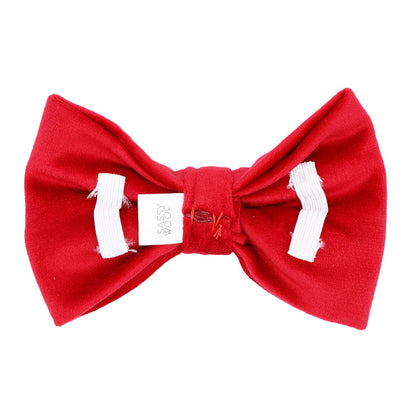 The Sassy Woof Dog Bowtie - Naughty is a bright red bow tie with white ribbon accents and a small "Sassy Woof" tag, perfect to pair with velvet dog accessories or your dog's favorite holiday collar.