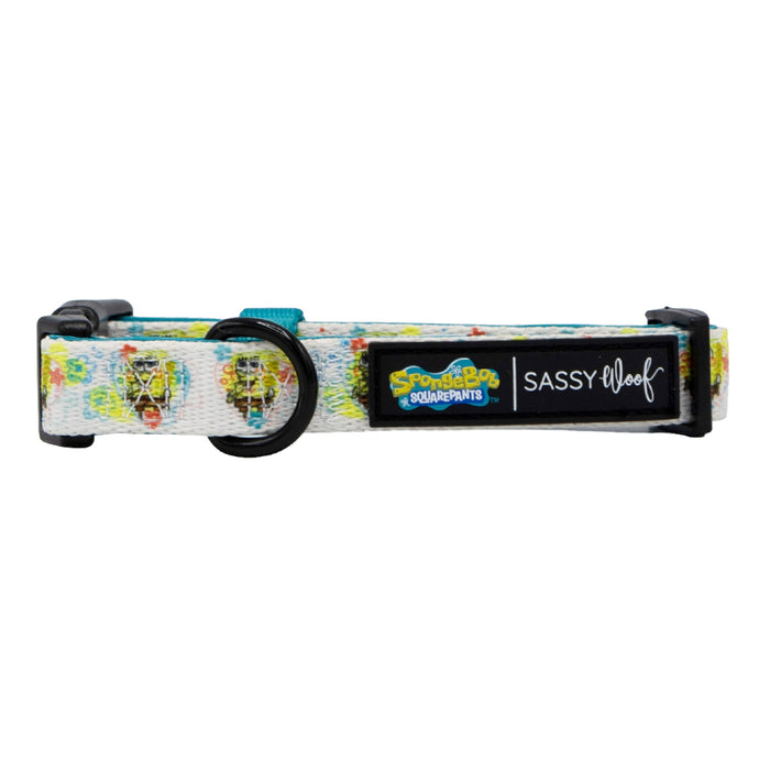 A white dog collar from the Sassy Woof Dog Collar Three Piece Bundle – SpongeBob SquarePants™ Bikini Bottom, featuring a playful SpongeBob SquarePants pattern, sturdy black buckle, and branded labels—ideal for fans seeking fun and stylish SpongeBob pet accessories.