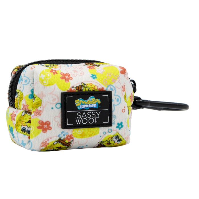 Compact, zippered pouch featuring SpongeBob SquarePants and flower designs, complete with a Sassy Woof label and black clip for easy attachment to bags or leashes—an ideal match with other Sassy Woof products like the Dog Collar Three Piece Bundle - SpongeBob SquarePants™ Bikini Bottom.