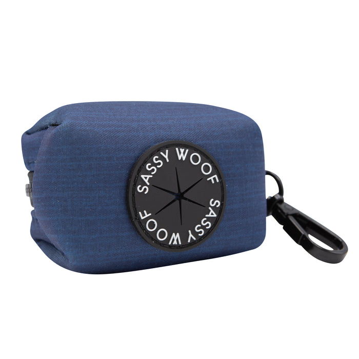 Twilight Collection bag dispenser from Sassy Woof, in blue fabric with a black label, features a circular opening and a black clip—perfect for pairing with your favorite dog leash or the Dog Collar Three Piece Bundle - Twilight.
