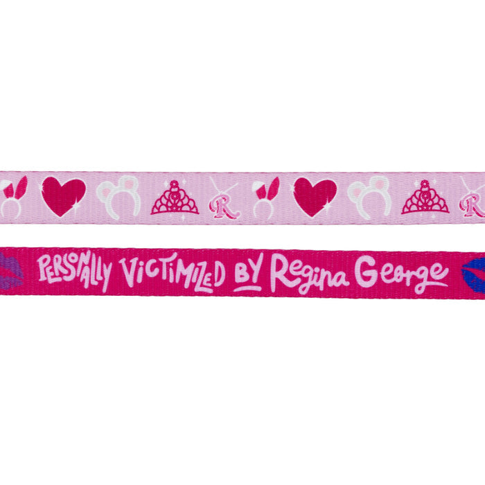 The Sassy Woof Dog Leash - Mean Girls™ features two pink ribbons: one with tiaras, hearts, and "R" motifs, the other reading "Personally Victimized by Regina George"—perfect for stylish dog walks.
