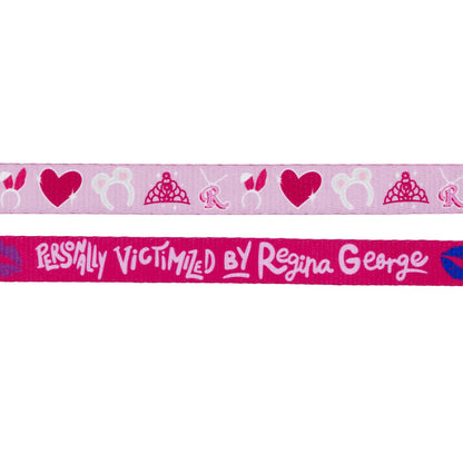 The Sassy Woof Dog Leash - Mean Girls™ features two pink ribbons: one with tiaras, hearts, and "R" motifs, the other reading "Personally Victimized by Regina George"—perfect for stylish dog walks.