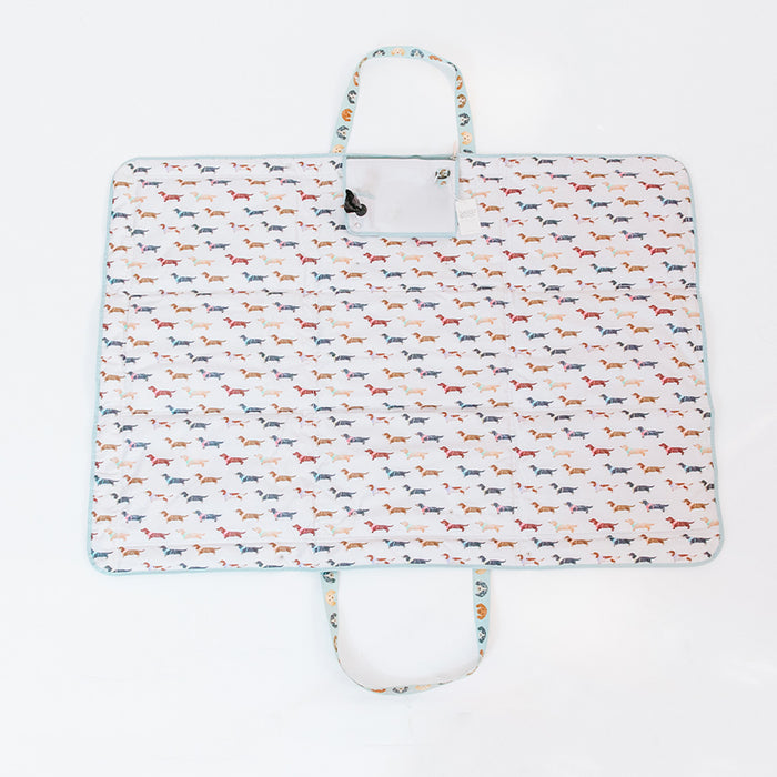 Carry your favorite Sassy Woof Dog Picnic Blanket - Dainty Dachshunds in a stylish white bag with dog prints—perfect for sunny picnics or outings.