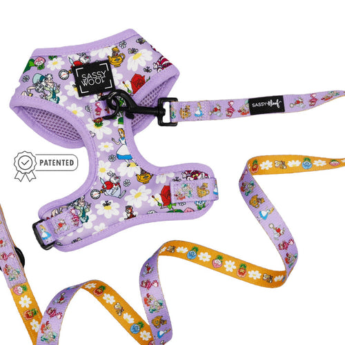 The Sassy Woof Dog Two Piece Bundle in purple features an adjustable harness with playful cartoon characters inspired by Alice in Wonderland.