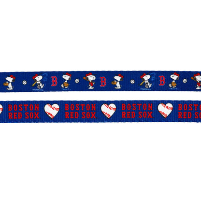 The Sassy Woof Dog Two Piece Bundle - MLB™ x Peanuts™ Boston Red Sox™ includes two blue ribbons: one with Snoopy in Red Sox gear and B logos, the other with “Boston Red Sox” text and white baseball hearts—ideal for matching harnesses or leashes.