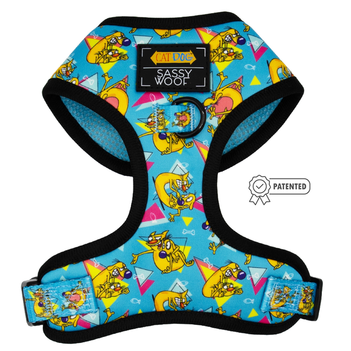 A blue adjustable harness from the Sassy Woof Dog Two Piece Bundle – Nickelodeon CatDog™ features black trim, a colorful CatDog pattern, and a patented icon to the right.