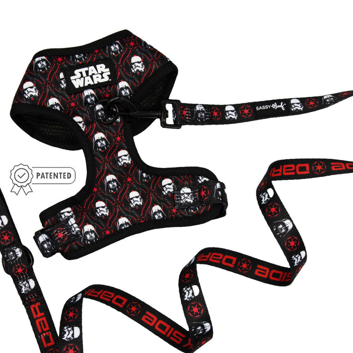 The Sassy Woof Dog Two Piece Bundle - STAR WARS™ The Dark Side includes a black adjustable dog harness and leash set with Stormtrooper helmets, red Imperial symbols, and a patented badge shown on the left.