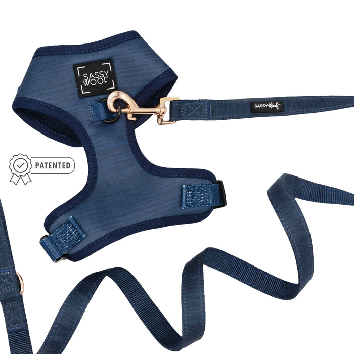 The Sassy Woof Dog Two Piece Bundle - Twilight, shown on a white background, features an adjustable blue harness with sturdy metal hardware and leash; a patented badge icon is displayed beside the set.