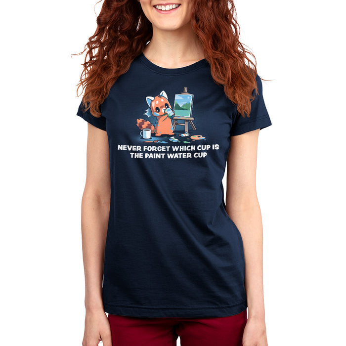 Premium Cotton T-shirt_TeeTurtle navy blue Don’t Drink the Paint Water featuring a red panda that’s painting a picture and taking a sip of paint water and looking at the mug of coffee on the floor with text that reads "Never Forget Which Cup Is The Paint Water Cup".