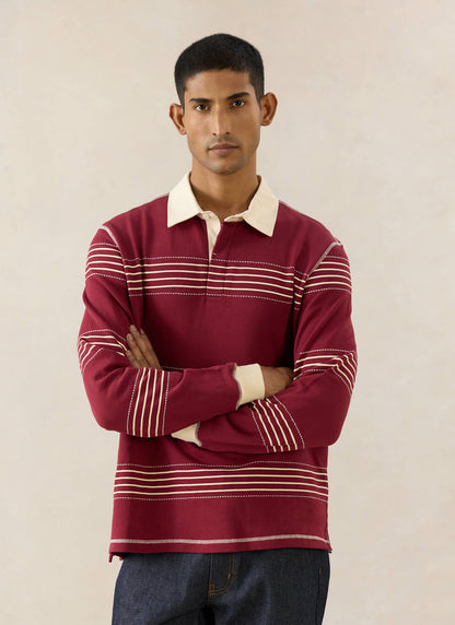 The Percival Editor Striped Rugby Polo in burgundy cotton with cream collar and stab stitched stripes and raw indigo denim.