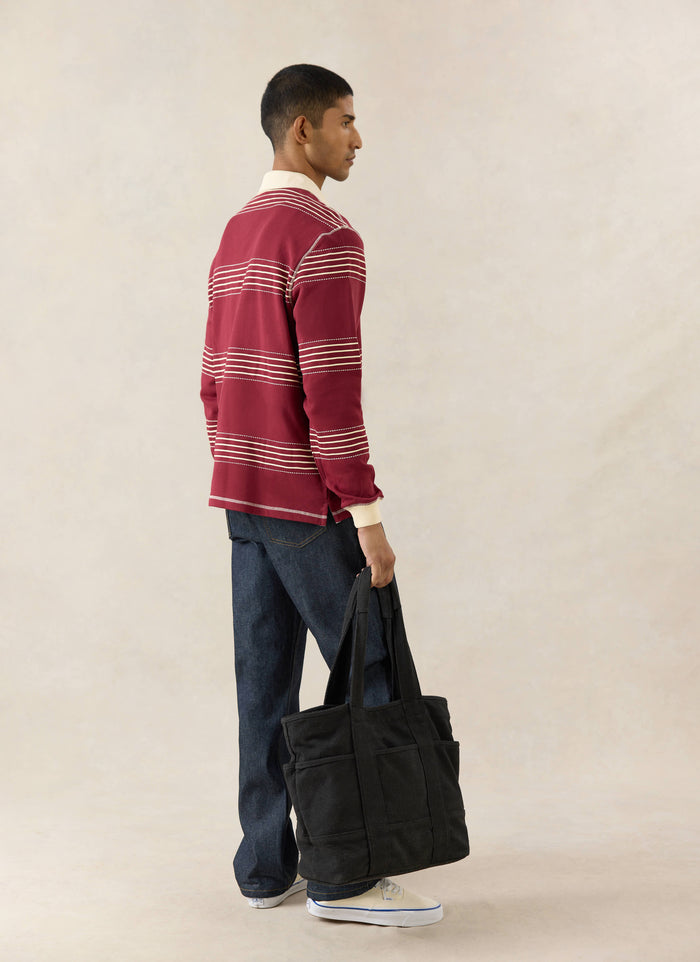 New Season burgundy Percival Editor Striped Rugby Polo in cotton with stab stitching and cream collar in side profile.
