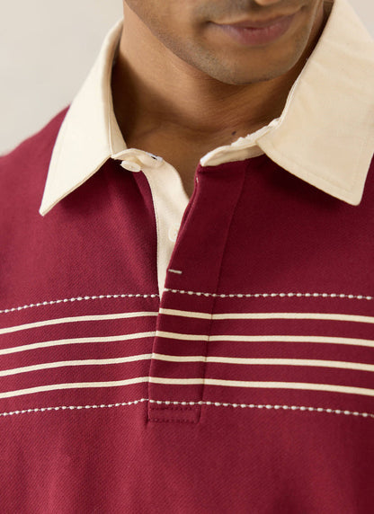 Percival Editor Striped Rugby Polo in burgundy cotton, with white stab stitching and a cream contrast collar on a model.