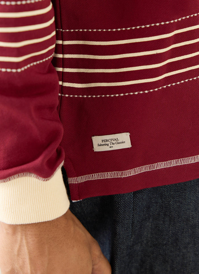 Burgundy Percival Editor Striped Rugby Polo with cream stripes, stab stitching details, and a woven label at the hem.