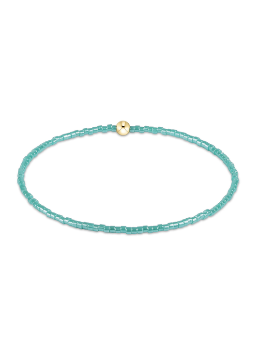 Blue beaded bracelet on a white background