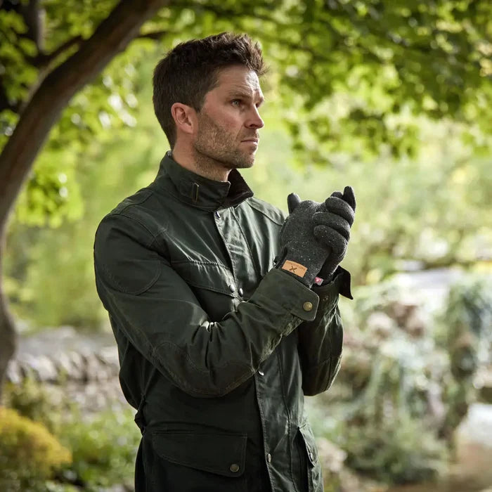 Lifestyle shot of a man outdoors wearing a pair of Extremities Furnace Pro Glove