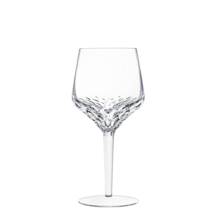 A clear Folia Stemware wine glass by Saint-Louis/Hermès, featuring a textured, patterned bowl and a smooth, slender stem, stands upright against a plain white background. Expertly mouthblown and hand-cut, this elegant piece highlights exquisite craftsmanship.