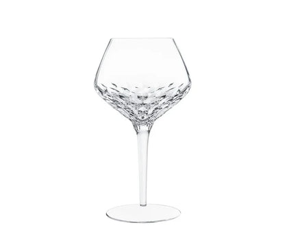 Mouthblown Folia Stemware crystal wine glass with an angled bowl featuring faceted, leaf-like cut patterns and a slender stem.