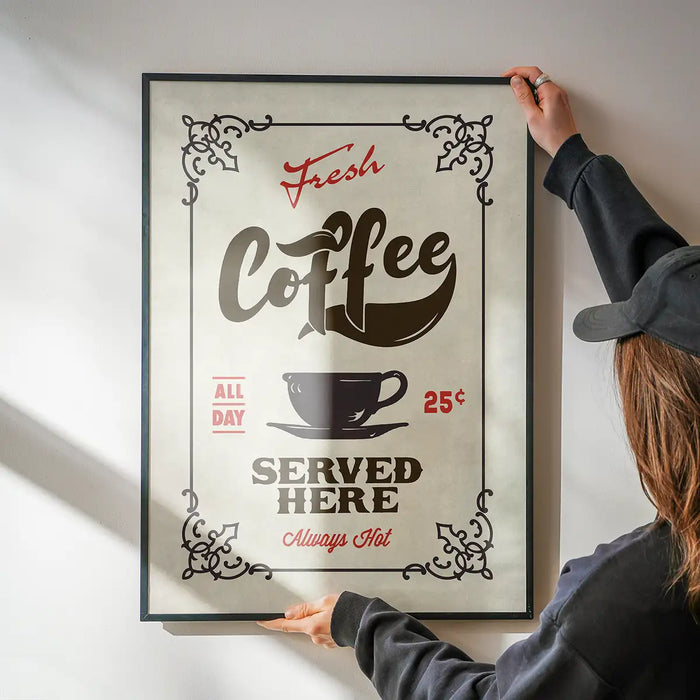 Fresh Coffee Served Here Colour Print being hung on a wall in a black frame